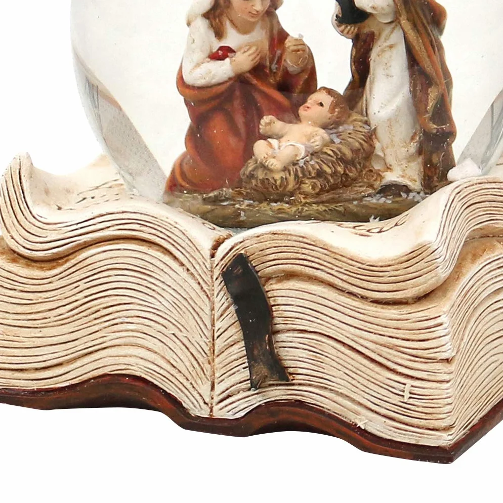 Dekohelden24 Kula śnieżna ze Świętą Rodziną, wymiary wys./szer./Ø kuli: ok. 9 x 7,5 cm, Ø 6,5 cm na książce